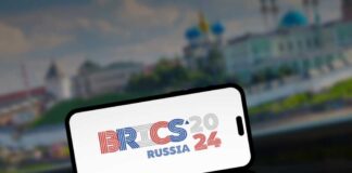 Smartphone displaying BRICS 2024 Russia logo.